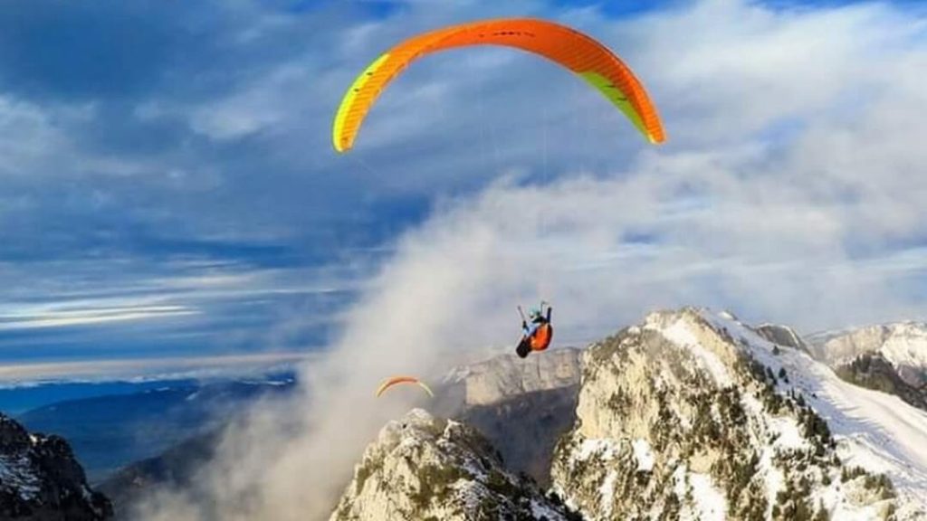 Activity in Dharamshala: Adventurers take flight over Dharamshala's breathtaking landscapes, enjoying the thrill of paragliding against a backdrop of lush green hills and clear blue skies.
